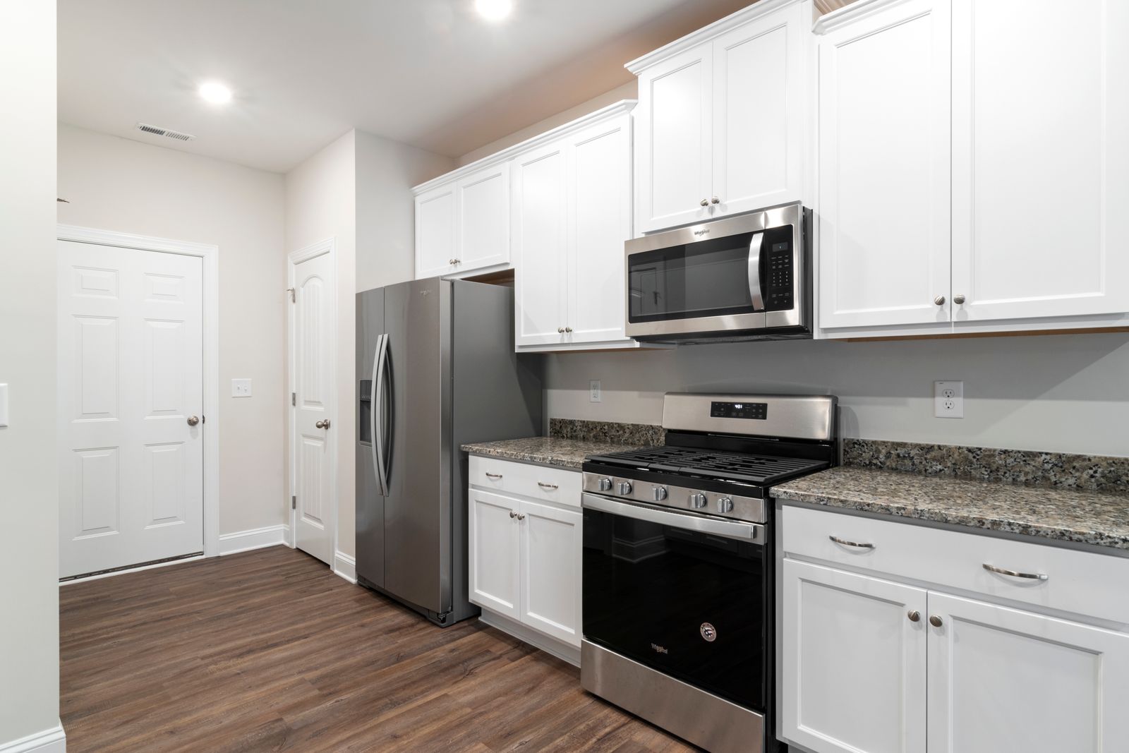 Simple white kitchenette with fridge and stove